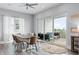 Dining room with a large sliding glass door out to a furnished patio overlooking the waterway at 371 12Th Ave, Indian Rocks Beach, FL 33785