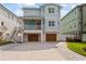 Charming, light blue two-story home with a covered porch and two-car garage and paved driveway at 371 12Th Ave, Indian Rocks Beach, FL 33785