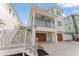 Beautiful home showcasing a two-car garage and covered outdoor living space with private entrance at 371 12Th Ave, Indian Rocks Beach, FL 33785