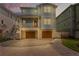 Beautiful exterior of blue two-story house with garages, a golf cart, and two balconies at 371 12Th Ave, Indian Rocks Beach, FL 33785