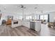 Spacious, open kitchen with white cabinets, stainless appliances, and an island with bar seating overlooks the living space at 371 12Th Ave, Indian Rocks Beach, FL 33785