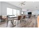 Bright open-concept living and dining area with modern furnishings and large windows overlooking the water at 371 12Th Ave, Indian Rocks Beach, FL 33785