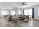 Open-concept living room features wood floors, lots of seating, and a view to an outdoor balcony at 371 12Th Ave, Indian Rocks Beach, FL 33785