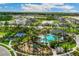 Aerial view of community amenities including a pool, playground, tennis courts, and lush landscaping at 3712 Forest Path Dr, Plant City, FL 33565
