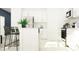 Bright white kitchen showcasing modern appliances, white cabinets, and an island with bar seating at 3712 Forest Path Dr, Plant City, FL 33565