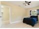 Light bedroom with modern ceiling fan, a picture window, and ample space at 4323 Culbreath Rd # B, Valrico, FL 33596