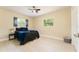 This bedroom features a ceiling fan, a picture window, and a closet at 4323 Culbreath Rd # B, Valrico, FL 33596