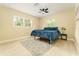 This bedroom features a ceiling fan, picture windows and a bed with a fluffy rug at 4323 Culbreath Rd # B, Valrico, FL 33596