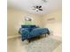 This bedroom features a ceiling fan, picture window, and bed with gray rug at 4323 Culbreath Rd # B, Valrico, FL 33596