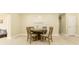 Cozy dining room with a round wooden table, cushioned chairs, and neutral wall decor at 4323 Culbreath Rd # B, Valrico, FL 33596
