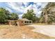Home featuring a covered carport, large concrete driveway and a spacious backyard at 4323 Culbreath Rd # B, Valrico, FL 33596