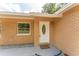 Up-close exterior home shot of front door and small bay window with brick exterior at 4323 Culbreath Rd # B, Valrico, FL 33596