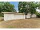 Detached garage with white exterior and surrounding foliage, offering parking and/or outdoor storage space at 4323 Culbreath Rd # B, Valrico, FL 33596