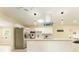 Well-lit kitchen with white cabinetry, a stainless steel refrigerator, and an open layout at 4323 Culbreath Rd # B, Valrico, FL 33596