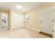 Neutral room featuring double closet, access to bathroom, exterior door, and space for washer and dryer at 4323 Culbreath Rd # B, Valrico, FL 33596