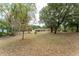 Wide shot of the property and lawn surrounded by large trees, providing a tranquil and secluded environment at 4323 Culbreath Rd # B, Valrico, FL 33596