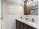 Bathroom featuring a double vanity with dark wood cabinets and granite countertop at 4331 13Th Ne Way, St Petersburg, FL 33703