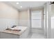 Spa-like bathroom featuring a luxurious soaking tub, a separate shower, and elegant tile work at 4331 13Th Ne Way, St Petersburg, FL 33703