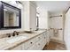 Bright bathroom featuring a double vanity with white cabinets and granite countertop at 4331 13Th Ne Way, St Petersburg, FL 33703