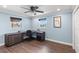 Bedroom featuring hardwood floors, a ceiling fan, and a built-in desk at 4331 13Th Ne Way, St Petersburg, FL 33703