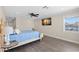 Bright, airy bedroom featuring wood floors, modern decor, and a view of the waterfront at 4331 13Th Ne Way, St Petersburg, FL 33703