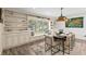 Bright dining room with large windows, built-in shelving, and a modern chandelier at 4331 13Th Ne Way, St Petersburg, FL 33703