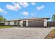 Lovely one-story home featuring a manicured lawn, brick driveway, and attached garage at 4331 13Th Ne Way, St Petersburg, FL 33703