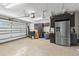 Spacious garage with epoxy flooring, stainless steel refrigerator, cabinets, and ample storage at 4331 13Th Ne Way, St Petersburg, FL 33703