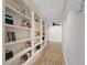 Hallway with hardwood floors and built-in bookshelves at 4331 13Th Ne Way, St Petersburg, FL 33703