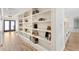 Hallway with hardwood floors and built-in bookshelves at 4331 13Th Ne Way, St Petersburg, FL 33703