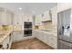 Elegant kitchen with stainless steel appliances, granite countertops, and ample cabinet space at 4331 13Th Ne Way, St Petersburg, FL 33703