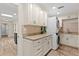 Laundry room featuring granite countertops, lots of cabinet space, and a stacked washer/dryer unit at 4331 13Th Ne Way, St Petersburg, FL 33703