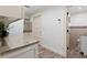 Laundry room with granite countertops and access to an adjacent half bathroom at 4331 13Th Ne Way, St Petersburg, FL 33703