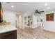 Spacious living room with hardwood floors, built-in bookshelves, and an adjacent kitchen area at 4331 13Th Ne Way, St Petersburg, FL 33703