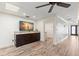Living room with hardwood floors, a granite-top media console, and an open entranceway at 4331 13Th Ne Way, St Petersburg, FL 33703