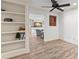 Open living area with hardwood floors and built-in shelves at 4331 13Th Ne Way, St Petersburg, FL 33703