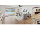 An open living room with waterfront views from large sliding doors, stylish decor, and ample seating at 4331 13Th Ne Way, St Petersburg, FL 33703