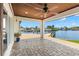 Tile patio with wooden ceiling overlooking waterfront canal and boat dock at 4331 13Th Ne Way, St Petersburg, FL 33703
