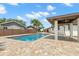 Beautiful pool with a brick patio, covered area, and palm trees providing a tropical oasis at 4331 13Th Ne Way, St Petersburg, FL 33703
