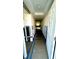 Long hallway during remodel phase with the drywall cut out and blue painters tape on floor at 4570 Overlook Ne Dr # 180, St Petersburg, FL 33703