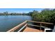 Scenic lake view from a well-maintained wooden deck with seating area at 4570 Overlook Ne Dr # 180, St Petersburg, FL 33703