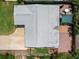 Aerial view of home's roof, lawn, driveway, and patio with shade structure at 460 4Th S St, Safety Harbor, FL 34695