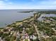 Aerial view of residential home near a bay, surrounded by trees and other homes at 460 4Th S St, Safety Harbor, FL 34695