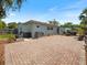 This backyard features a brick patio, a privacy fence, and shade at 460 4Th S St, Safety Harbor, FL 34695