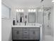 Modern bathroom boasts double vanity, sleek fixtures, and glass-enclosed shower at 460 4Th S St, Safety Harbor, FL 34695