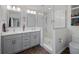 Modern bathroom with dual vanity sinks, sleek tile, and glass-enclosed shower at 460 4Th S St, Safety Harbor, FL 34695