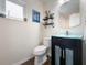 This bathroom features a modern vanity, elegant mirror, stylish shelving, and wood-look flooring at 460 4Th S St, Safety Harbor, FL 34695