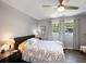 This cozy bedroom features a ceiling fan, two windows, and hardwood floors at 460 4Th S St, Safety Harbor, FL 34695