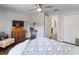 This bedroom includes hardwood floors, a ceiling fan, and a television at 460 4Th S St, Safety Harbor, FL 34695