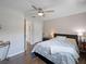 This bedroom includes hardwood floors, a ceiling fan, and two doors at 460 4Th S St, Safety Harbor, FL 34695